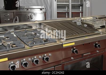 Gas Hob Stove and Grill in Professional Kitchen Restaurant Stock Photo