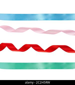 green and blue straight, curled red and pink satin ribbons isolated on white background, festive backdrop Stock Photo