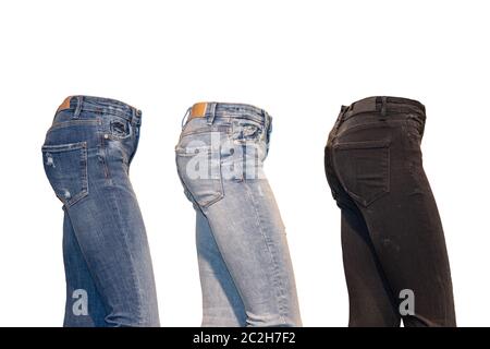 Set jeans isolated. Side view of a collection of three various denim pants on a ghost mannequin isolated on a white background. Advertising jeans shop Stock Photo