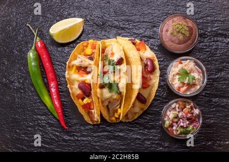 three mexican tacos on slate Stock Photo