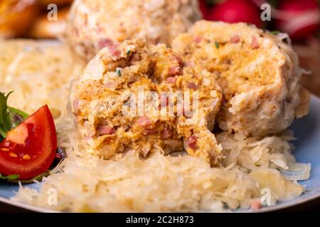 two speckknoedel with sauerkraut on wood Stock Photo