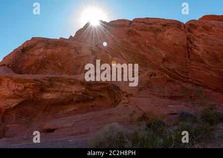 Sun flare over red rocks Stock Photo - Alamy