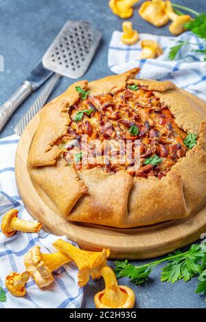 Traditional pie (Galette) with wild chanterelles. Stock Photo