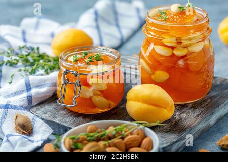 Apricot homemade jam with almonds in glass jars. Stock Photo