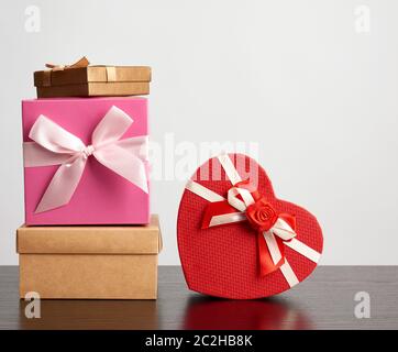 stack of various cardboard boxes for gifts on a black table, white background Stock Photo