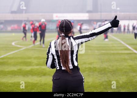 rear view of female american football referee Stock Photo