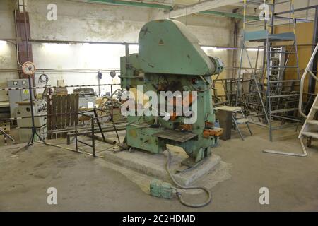 Old massive metalworking machine in the workshop Stock Photo
