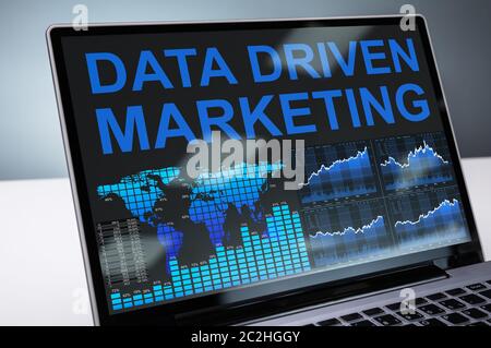 Data Driven Marketing Graph On Laptop In Office Stock Photo
