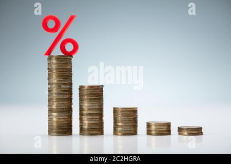 Interest Rate Decreasing Graph Made Of Stacked Coins Stock Photo