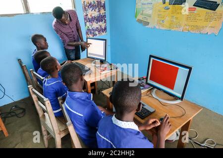 Teachers and students during computer classes at St. Martin Des Porres School in Aiyinasi-Awiaso, Ghana, Africa Stock Photo