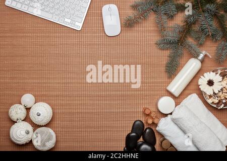 Spa composition, computer keyboard, fir branch and Christmas ornaments on bamboo mat background. Top view with copy space. Christmas and New Year sale Stock Photo