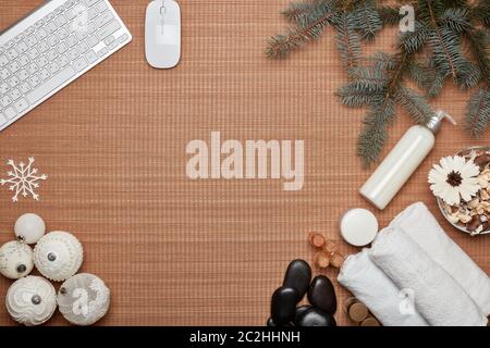 Spa composition, computer keyboard, fir branch and Christmas ornaments on bamboo mat background. Top view with copy space. Christmas and New Year sale Stock Photo