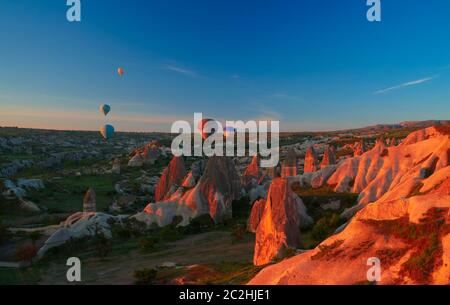 Sunrise panoramic view to Goreme city and flying balloons, Cappadocia, Turkey Stock Photo