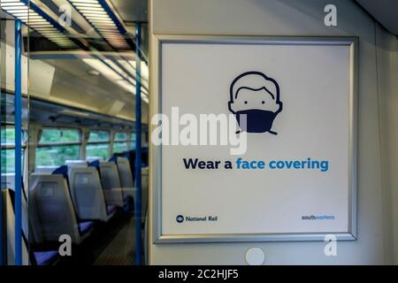 17th June 2020. A sign on a Southeastern train informs passengers that the wearing of face coverings is mandatory on all public transport. London UK. Stock Photo