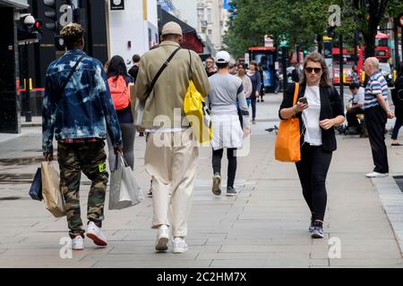 17th June 2020. Shoppers on Oxford Street, London following the government's easing of Covid-19 lockdown measures in England allowing non-essential retail outlets to reopen. Stock Photo