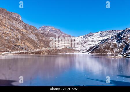 Tsomgo Lake (Tsongmo or Changu Lake) frozen during winter season. It is a glacial lake in East Gangtok Sikkim of India. Lake surface reflects differen