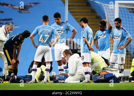 Manchester City's Eric Garcia receives treatment on the floor after a collision with goalkeeper Ederson (not pictured) during the Premier League match at the Etihad Stadium, Manchester. Stock Photo