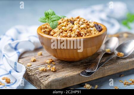 Granola with baked apple in a wooden bowl. Stock Photo