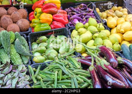 Different kinds of vegetables and lemons for sale at a market Stock Photo