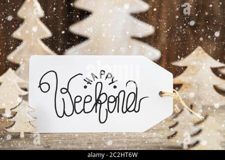 Label With English Text Happy Weekend. White Wooden Christmas Tree As Decoration. Brown Wooden Background With Snow Stock Photo