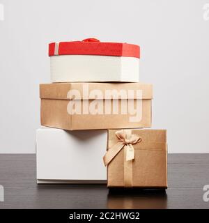 stack of various cardboard boxes for gifts on a black table, white background Stock Photo