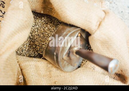 Bag of raw coffee beans ready to be roasted Stock Photo