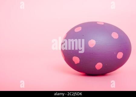 Beautiful Easter purple egg color on pink background, Easter day concept Stock Photo
