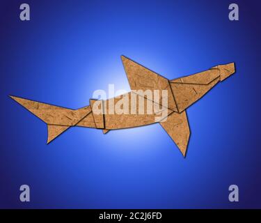 origami sharks made of paper on blue background Stock Photo