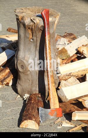 Split firewood with ax and block Stock Photo