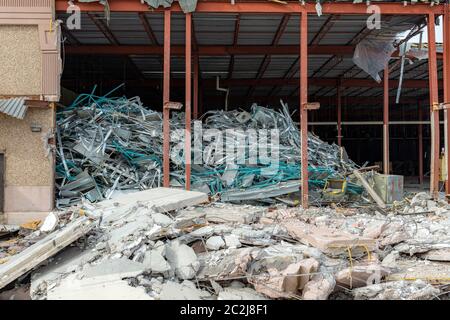 part of broken down building still standing among rubble and debris ...