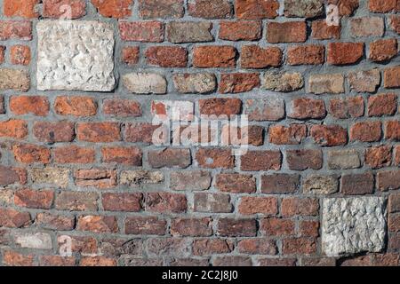 Old faded decayed brick wall pattern background Stock Photo