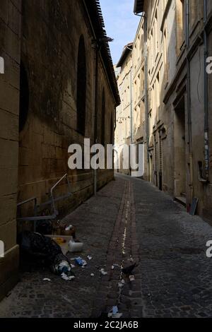 Narrow old gothic quarter streets littered with rubbish (garbage)Bordeaux City, France August 2019 Stock Photo