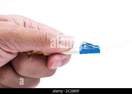 Hand hold plug fiber optic cables single mode LC isolated on white background Stock Photo