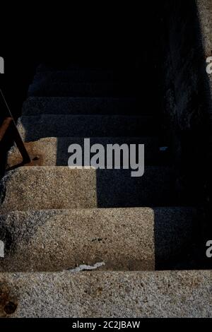 Worn concrete steps in deep shadow, abstract detail, Bacalan docks, Bordeaux, France Stock Photo