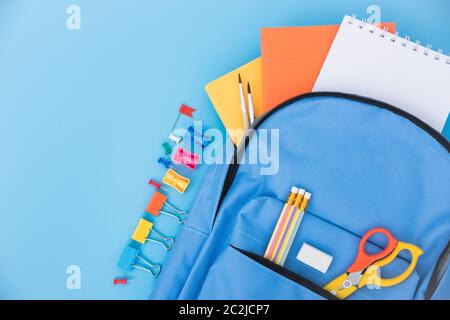 Top view Blue bag backpack for education children on blue background back to school concept Stock Photo