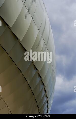 Abstract close-up of curved metal panels on La Cité du Vin against a cloudy sky, Bordeaux, France Stock Photo