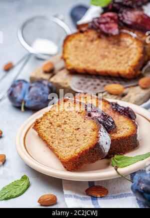 Slices of traditional plum cake on ceramic plate. Stock Photo