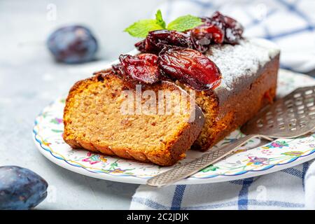 Sliced plum cake with almonds and spiced plum. Stock Photo