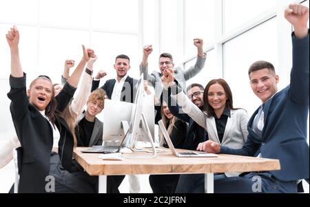 large group of diverse employees celebrate while sitting at a table Stock Photo