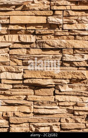 Tile stone wall pattern texture. For background or floor. Fragment of a wall from a chipped stone Stock Photo