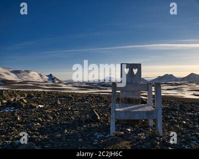 A chair with two hearts stands on a small hill in Iceland Stock Photo