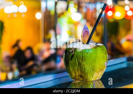 Fresh coconut drink served in the bar on the famous Train Street, popular tourist destination in old town Hanoi by night Stock Photo