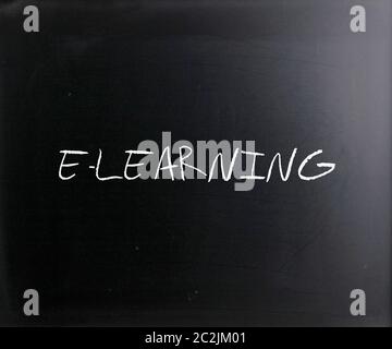 "E-learning" handwritten with white chalk on a blackboard. Stock Photo