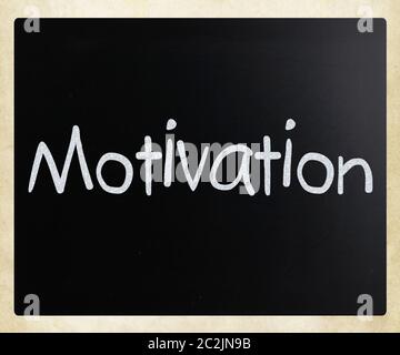 "Motivation" handwritten with white chalk on a blackboard Stock Photo