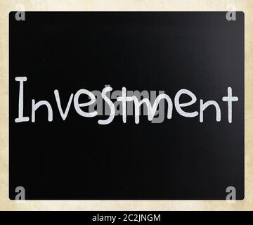 The word 'Investment' handwritten with white chalk on a blackboard Stock Photo
