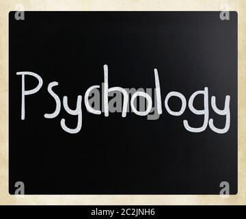 The word 'Psychology' handwritten with white chalk on a blackboard Stock Photo