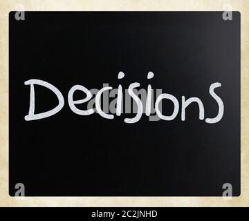 The word "Decisions" handwritten with white chalk on a blackboard Stock Photo