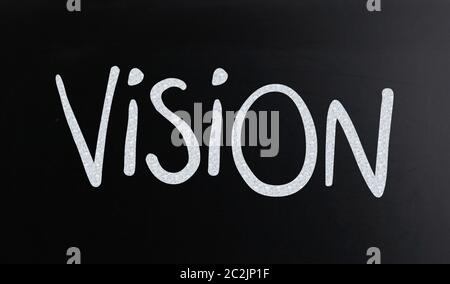 The word "Vision" handwritten with white chalk on a blackboard Stock Photo