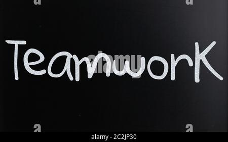 The word "Teamwork" handwritten with white chalk on a blackboard Stock Photo