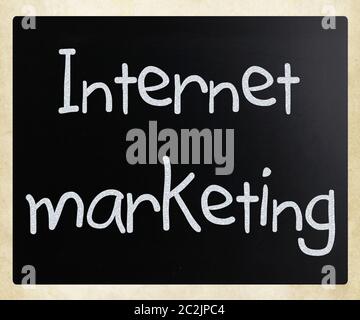 "Internet marketing" handwritten with white chalk on a blackboard Stock Photo